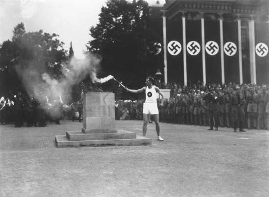 The last of the 3,000 runners who carried the Olympic torch from Greece lights the Olympic Flame in Berlin to start the 11th Summer ...