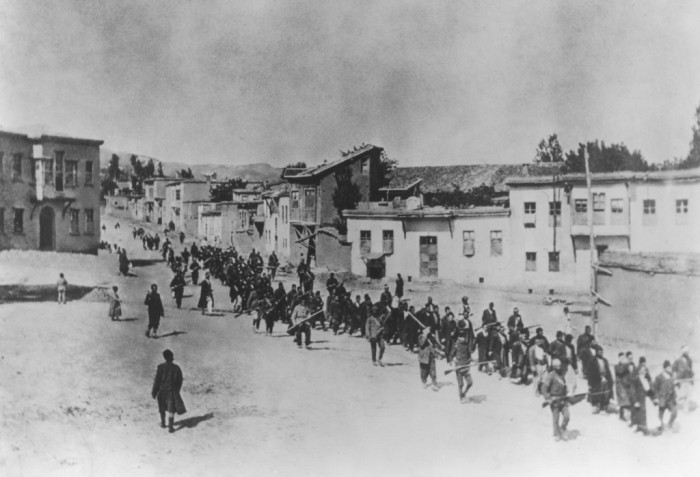 Ottoman military forces march Armenian men from Kharput to an execution site outside the city. Kharput, Ottoman Empire, March 1915-June 1915. [Courtesy of the Armenian National Institute.]