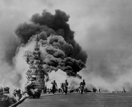 US sailors struggle to contain damage from Kamikaze attacks during the American invasion of Okinawa, the largest of the Ryukyu Islands (the islands closest to the Japanese home islands).