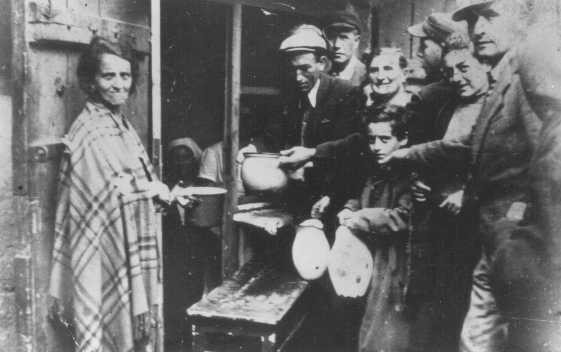 Poverty in the ghetto: residents wait for soup at a public kitchen. [LCID: 63023]