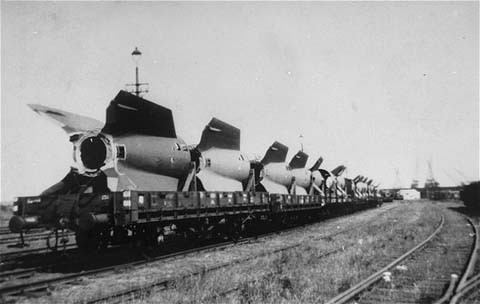 Sections of V-2 rockets, the so-called Vengeance Weapons, are removed by rail from the Dora-Mittelbau camp after liberation. [LCID: 01275]