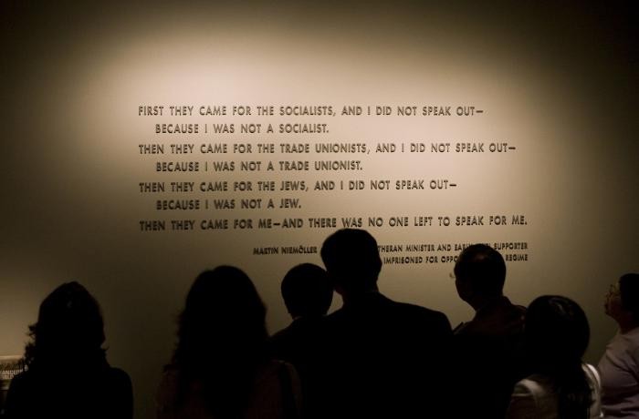 Quotation from Martin Niemöller on display in the Permanent Exhibition of the United States Holocaust Memorial Museum, with visitors