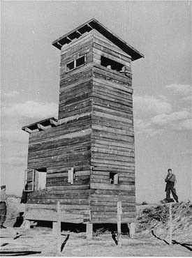 Ustasa (Croatian fascist) guard next to a watchtower at the Jasenovac concentration camp. [LCID: 90179]