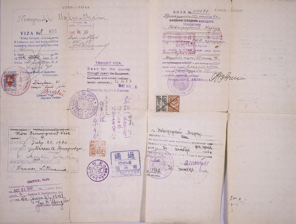 The backside of a Lithuanian safe conduct pass featuring a variety of stamps and notes. The pass has been folded multiple times, creating creases and torn edges.