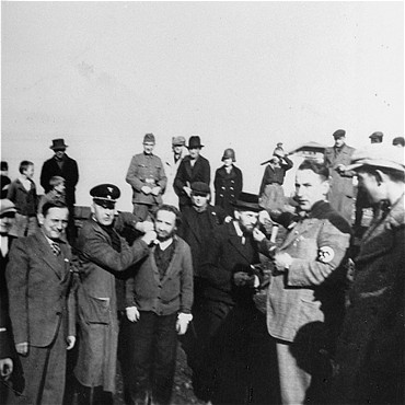 Germans humiliate religious Jews in Tarnow. Poland, 1940.
