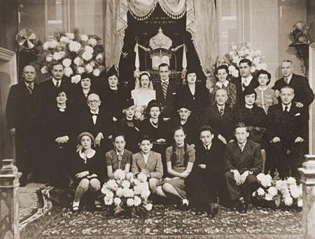 Bride and groom Laura Uziel and Saul Amarillo (center) pose with their extended families during their wedding. Salonika, Greece, 1938.