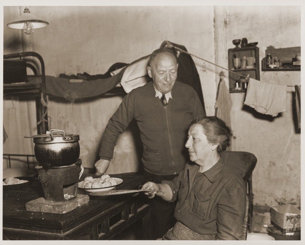 A Jewish refugee family prepares food with rations provided by the United Nations Relief and Rehabilitation Administration (UNRRA). [LCID: 66382]