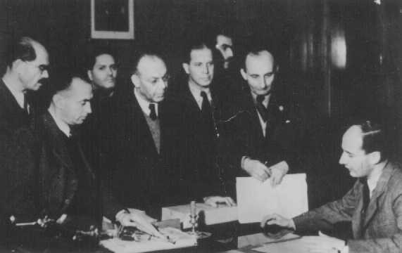 Raoul Wallenberg (seated) at the Swedish legation, with his Hungarian Jewish co-workers. [LCID: 74028]