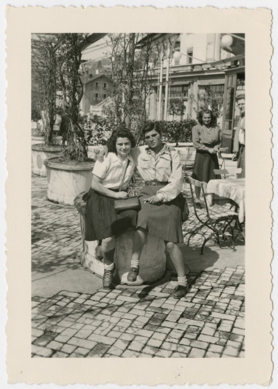 <p>Two women who came to Switzerland on the Kasztner tranport pose together at an outdoor cafe. Montreux, Switzerland, April 1945.</p>