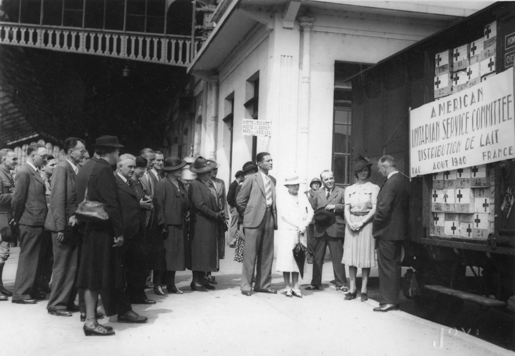 Martha Sharp stands next to her milk distribution center in Pau, France, 1940-1941.