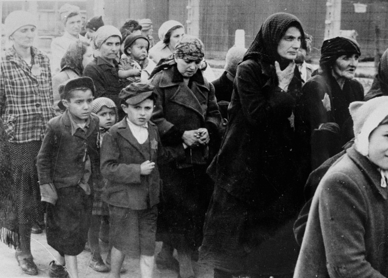 Jewish women and children from Subcarpathian Rus who have been selected for death at Auschwitz-Birkenau, walk toward the gas chambers. May 1944.