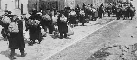 Jews carrying their possessions during deportation to the Chelmno killing center.