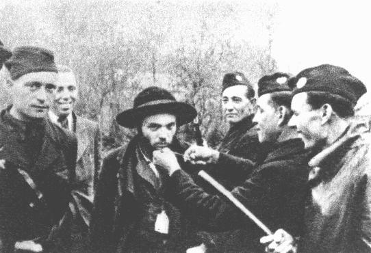  Slovakian collaborators cut off the beard of a Jewish man to publicly humiliate him before he is deported. [LCID: 77488b]