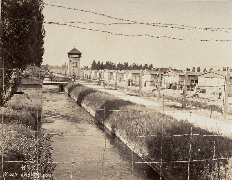 View of a section of the newly liberated Dachau concentration camp as seen through the barbed-wire fence.