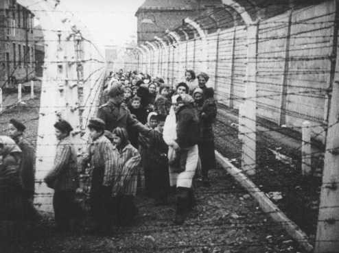  Child survivors leaving the Auschwitz camp after liberation.