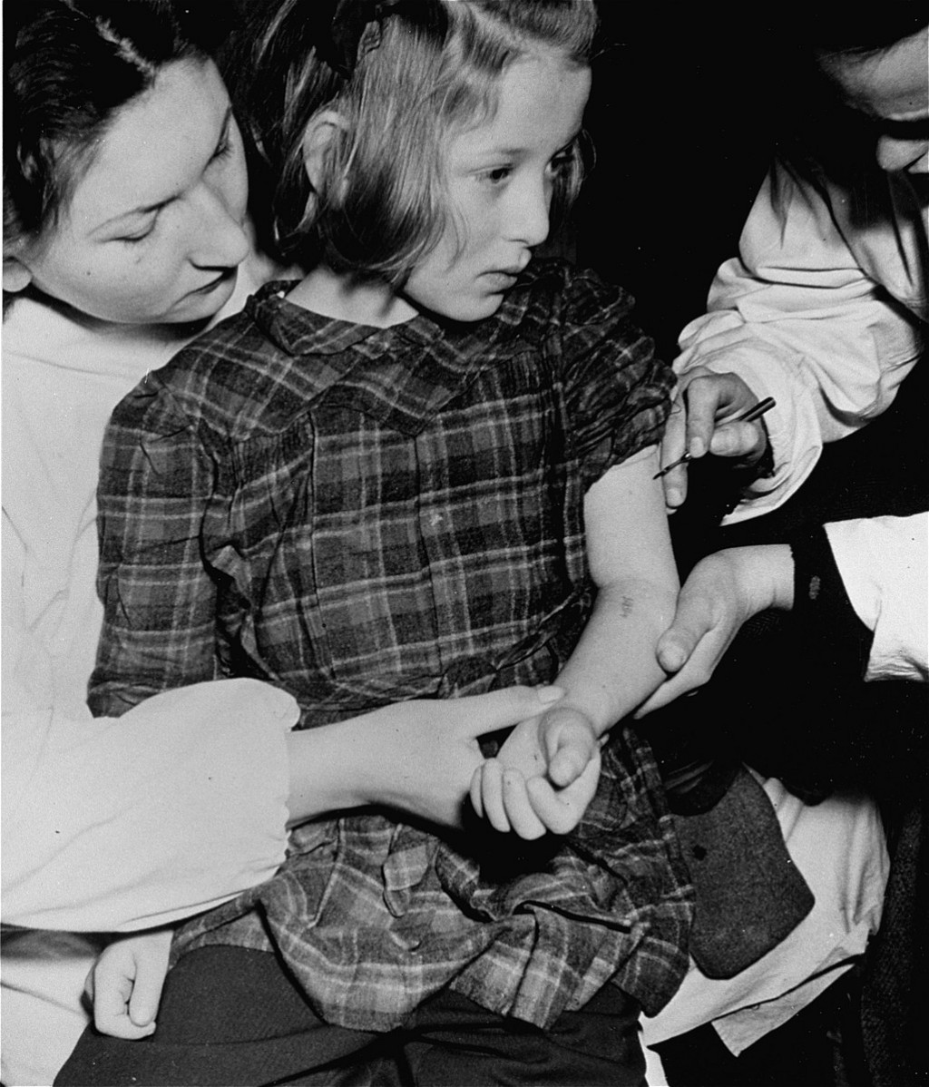 United Nations personnel vaccinate an 11-year-old concentration camp survivor who was a victim of medical experiments at the Auschwitz ...