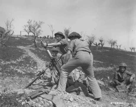 The 3-inch-mortar crew of the British army's Jewish Brigade Group, composed of volunteers from Palestine, fires on German positions during the final Allied offensive in Italy, March 30, 1945.