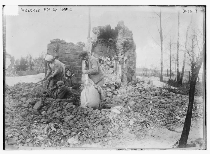 A man, women and a child sort through the rubble of a Polish home destroyed during World War I.