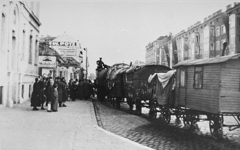 Onlookers watch during the resettlement of Romani (Gypsy) families from Vienna. Austria, September–December 1939.