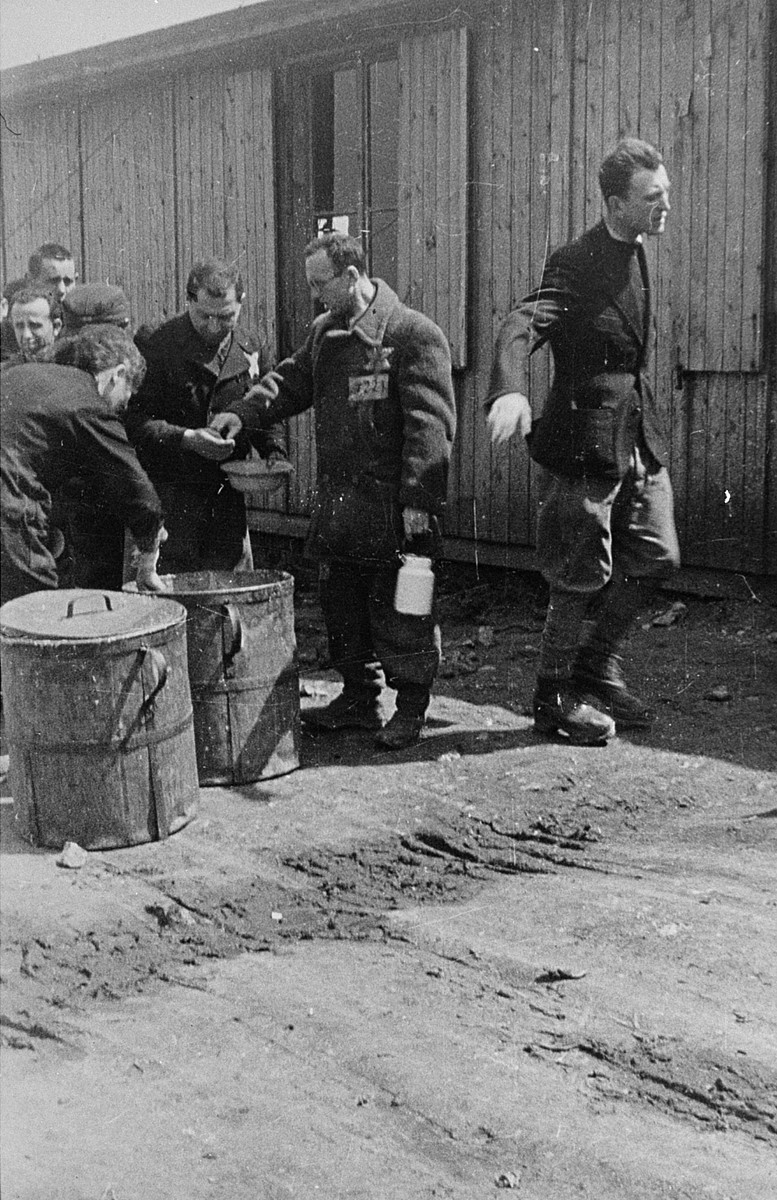 Prisoners receive meager food allocations at the Plaszow camp. [LCID: 03409]