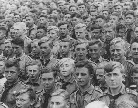  Hitler Youth members listen to a speech by Adolf Hitler at a Nazi "party day" rally.