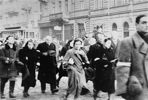 Jews from the Warsaw ghetto are marched through the ghetto during deportation.