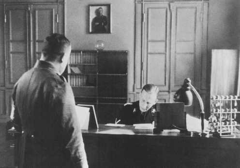 SS General Reinhard Heydrich in his office during his tenure as Bavarian police chief.