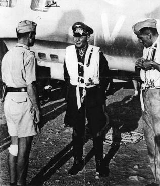 Erwin Rommel (center), commander of the Africa Corps, at an airfield in Libya during an Axis offensive into neighboring Egypt. [LCID: 90440]