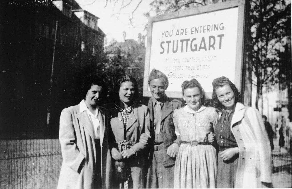 Henry Brauner (center) with his wife, Esther (second from right), pose with three friends in front of the entrance to the Stuttgart West displaced persons (DP) camp, 1945.