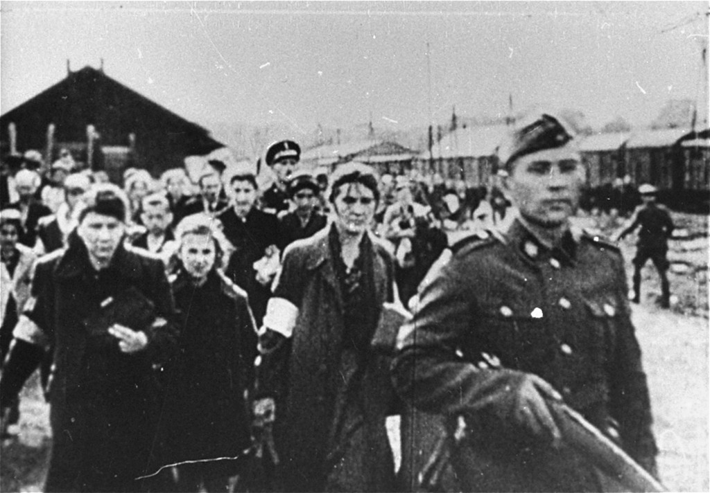 Jews under guard during deportation from the Warsaw ghetto. [LCID: 05528]