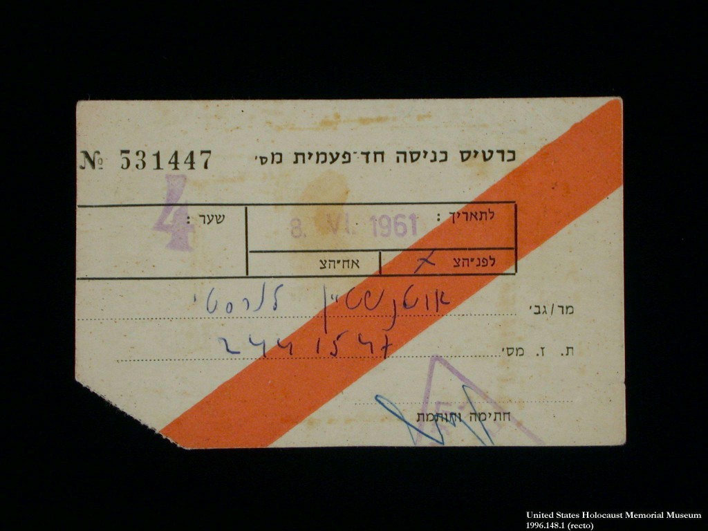 Paper entry pass with a bright orange diagonal line running from bottom left to top right. The bottom left corner has been cut off. Pass is number 5-3-1-4-4-7 with black printed type, handwritten blue ink, and remnants of a light purple stamp.