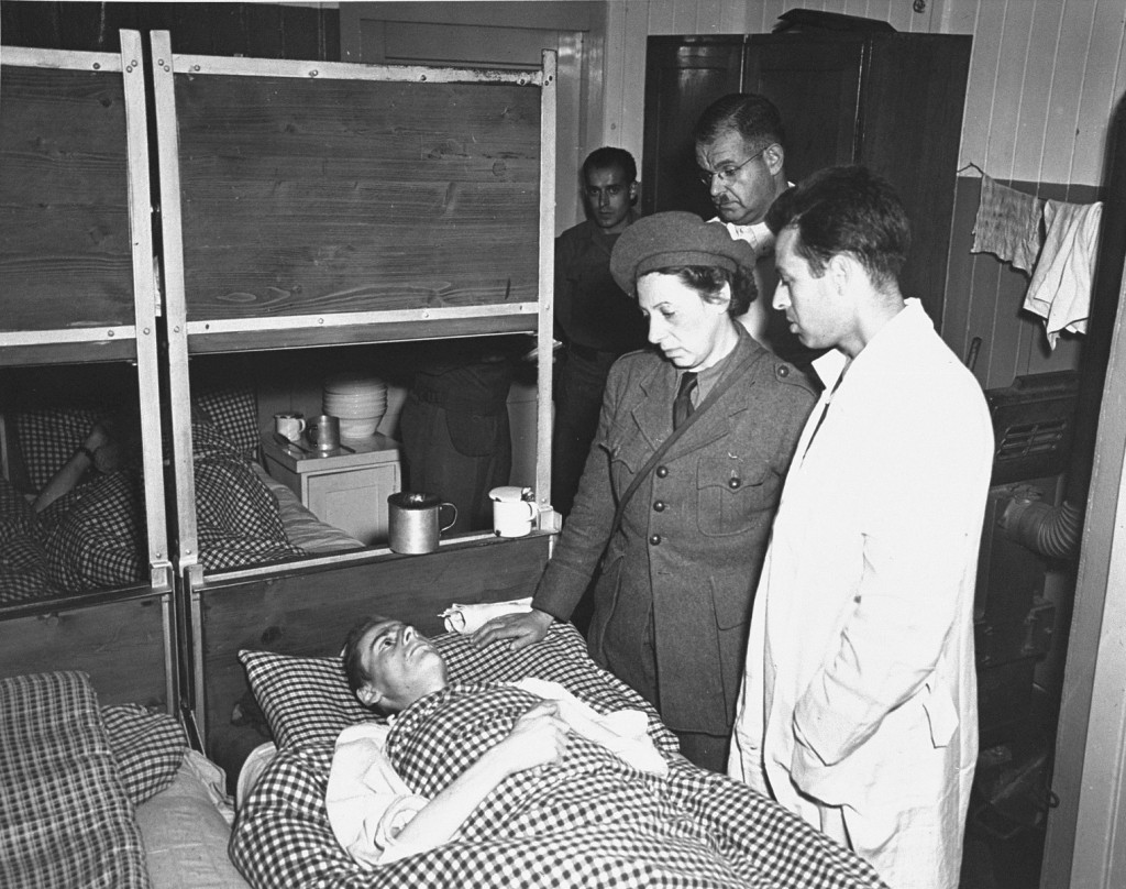 A United Nations Relief and Rehabilitation Administration (UNRRA) worker with a survivor of the Buchenwald concentration camp after ... [LCID: 67766]