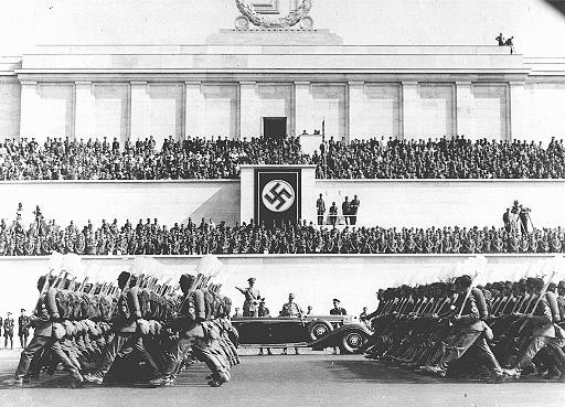 Reich Labor Service battalions parade before Hitler during the Nazi Party Congress.