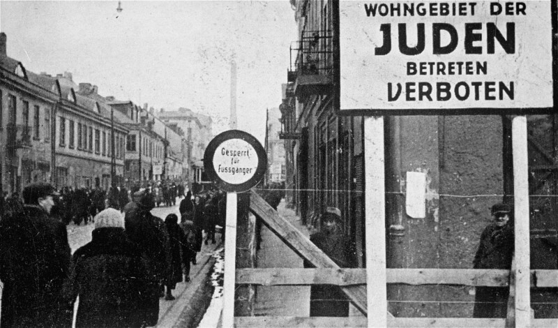 A German postcard showing the entrance to the Lodz ghetto. The sign reads "Jewish residential area—entry forbidden." Signs forbidding entrance to Poles and Germans were posted at all entrances to the ghetto. Lodz, Poland, 1940–1941.