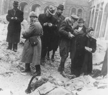 Families and friends of Jewish victims killed in the Budapest ghetto search for the exhumed corpses of friends and relatives.