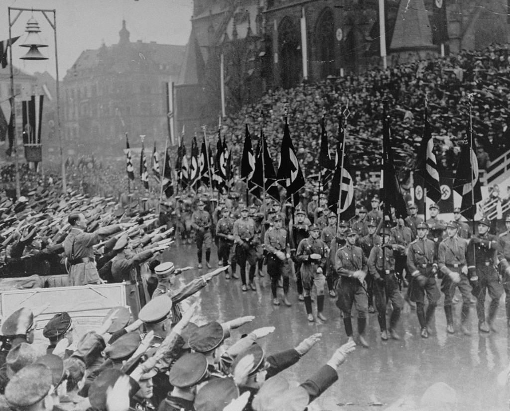 Hitler reviews a parade celebrating the reintegration of the Saar region into Germany.