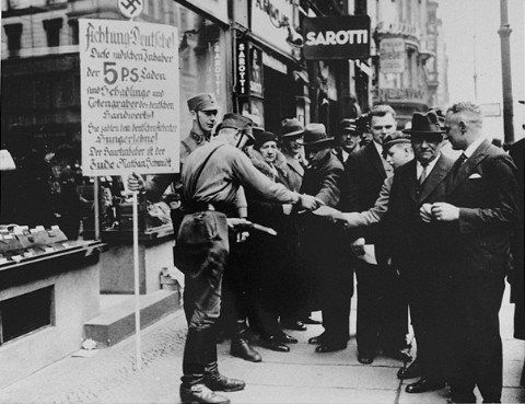 SA men distribute leaflets during the anti-Jewish boycott. [LCID: 77490]
