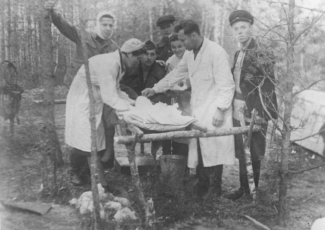 A wounded partisan is treated in a field hospital belonging to the Shish detachment of the Molotov brigade. [LCID: 56447]