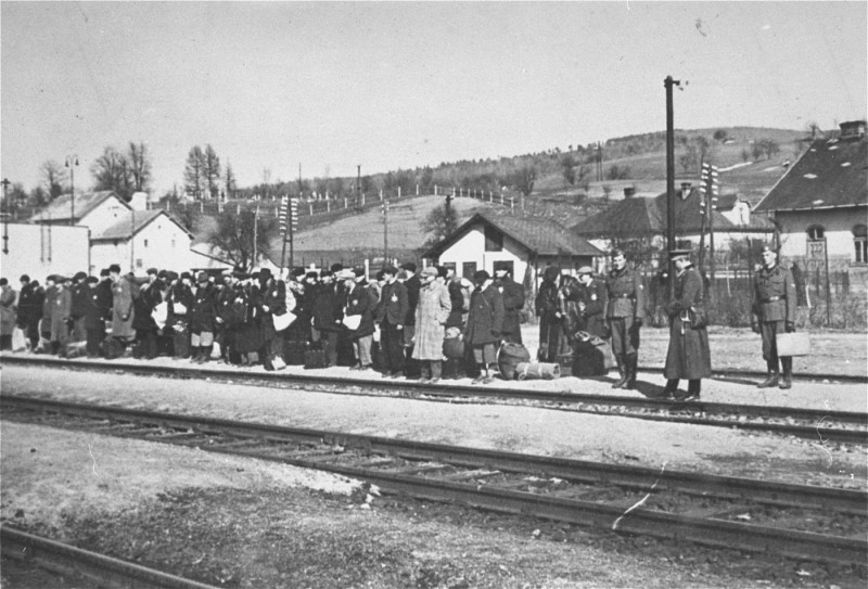 Jews at the railroad station before deportation. Puchov, Czechoslovakia, March 1942.