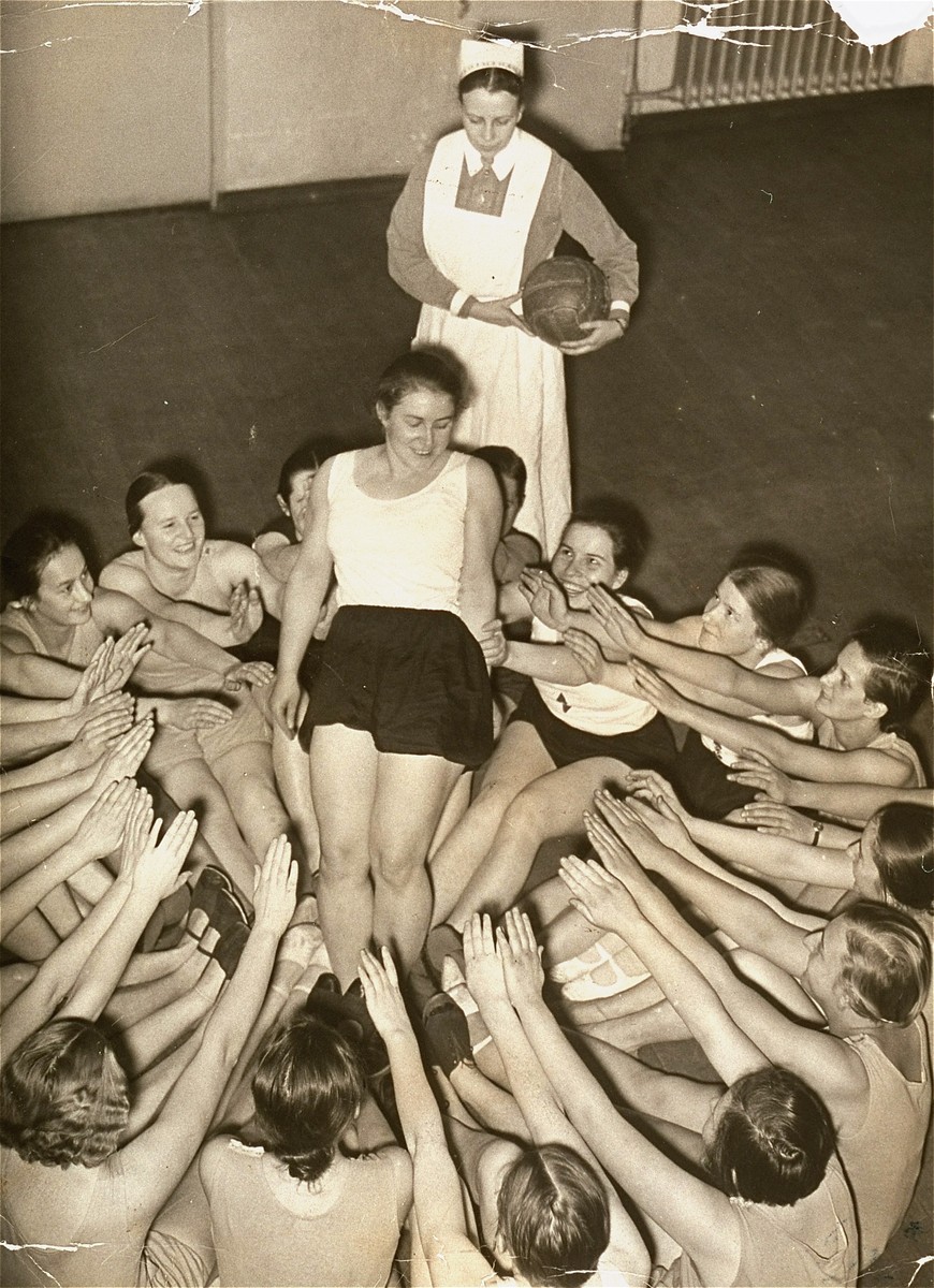 Members of the Nazi girls' organization, the League of German Girls (BDM), do a group exercise. [LCID: 09649]
