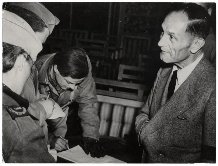 <p>Pastor Martin Niemöller speaks to reporters after his release from a concentration camp. Germany, 1945.</p>