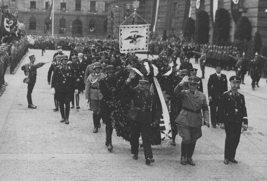  Ernst Roehm (front row, left), Hermann Goering (front row, center), and Heinrich Himmler (front row, right) en route to the opening ...