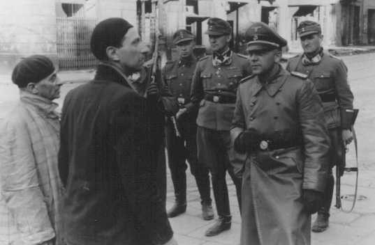 SS and Police Leader Juergen Stroop interrogates two Jews arrested during the Warsaw ghetto uprising.