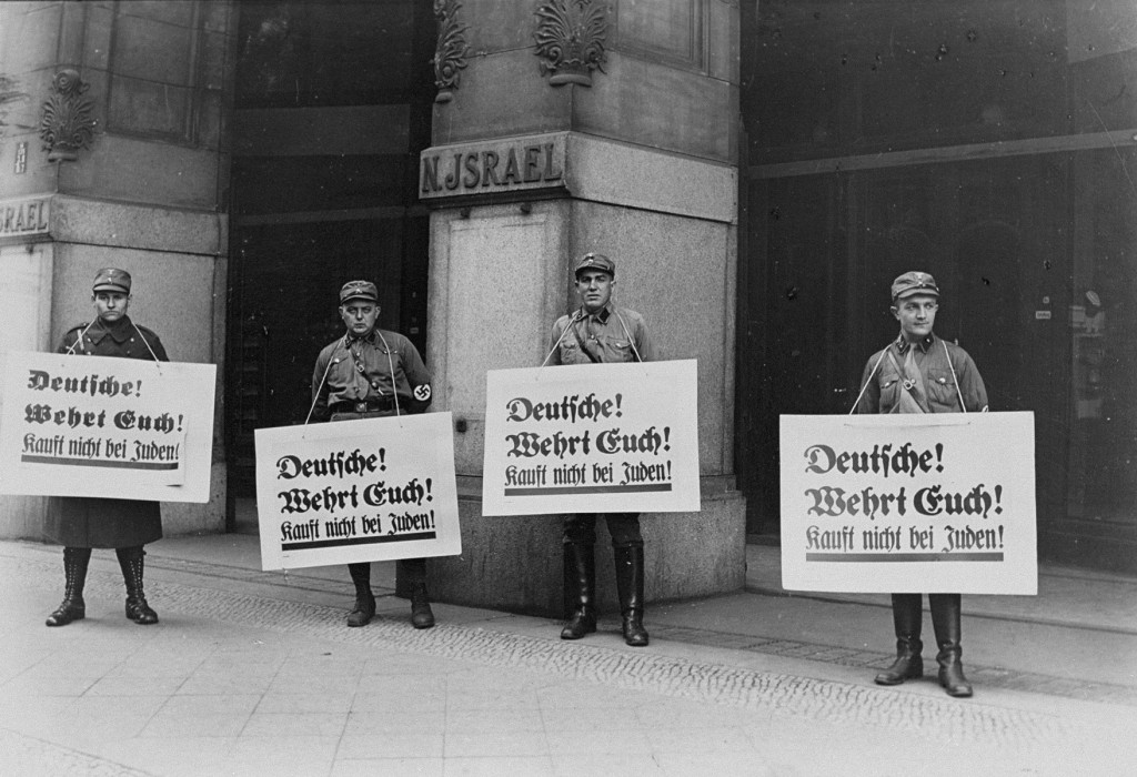 SA men in front of Jewish-owned store urge a boycott with the signs reading "Germans! [LCID: 66300b]
