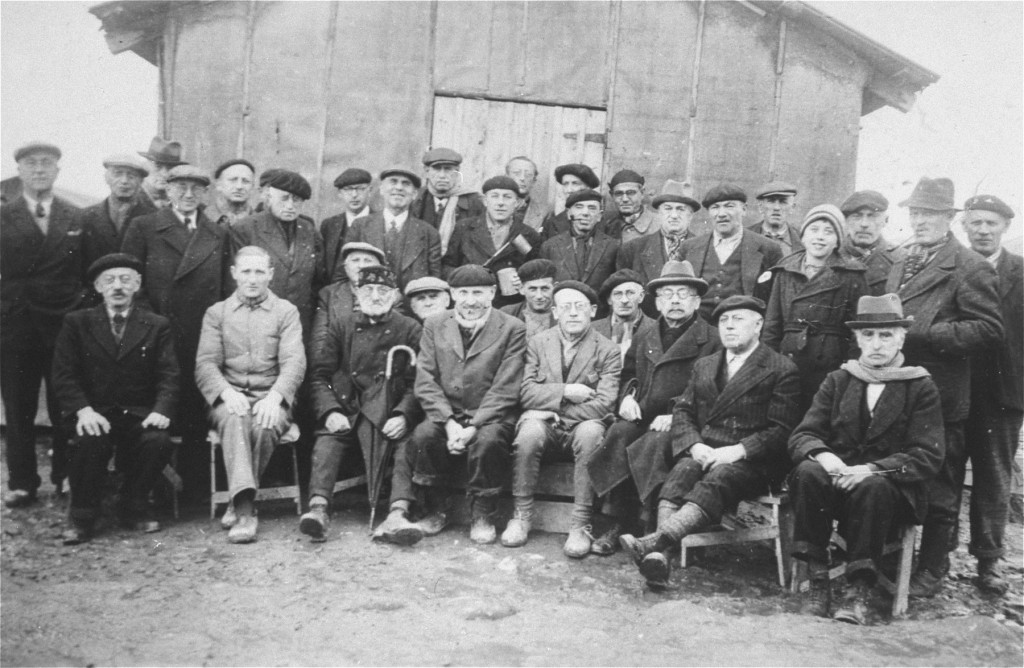 A group of  foreign-born Jews poses for a photo in Gurs, a French internment camp in southwestern France. [LCID: 80148]