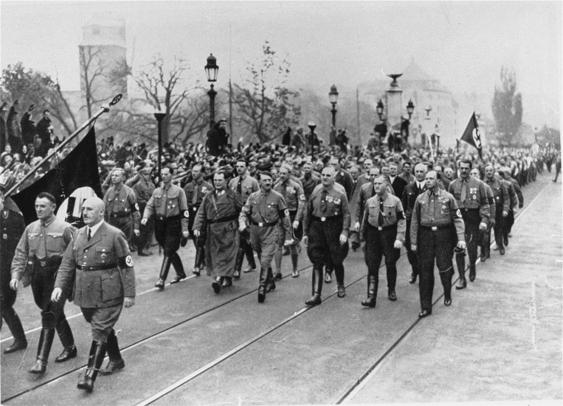 <p>Adolf Hitler, Julius Streicher (foreground, right), and Hermann Göring (left of Hitler) retrace the steps of the 1923 <a href="/narrative/11449">Beer Hall Putsch</a> (coup). Munich, Germany, November 9, 1934.</p>