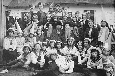 Group portrait of students at the Beis Yaakov religious school for girls dressed in costumes to celebrate the holiday of Purim.