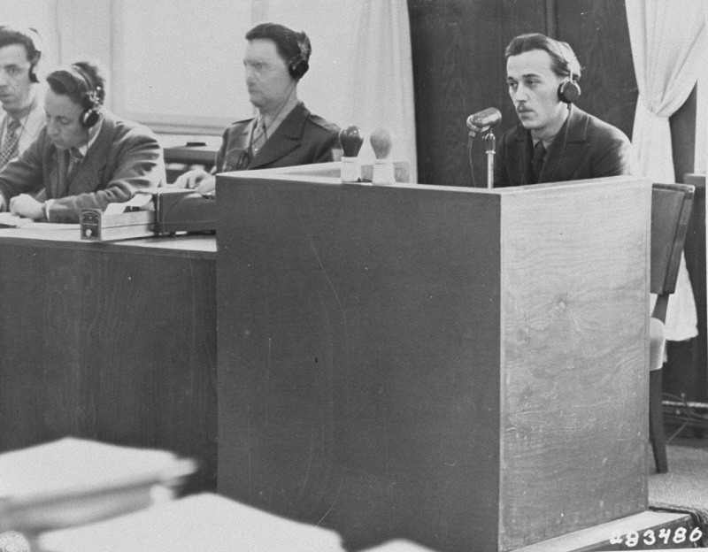 A Polish former inmate of Auschwitz identifies Oswald Pohl while on the stand for the prosecution during the Pohl/WVHA trial. This trial, case #4 of the Subsequent Nuremberg Proceedings, took place in a room in the Palace of Justice which was not the main courtroom. Nuremberg, Germany, April 18, 1947.