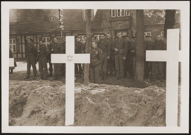 <p>After the <a href="/narrative/2317">liberation</a> of the camp, the US Army ordered the local townspeople to bury the corpses of prisoners killed in the camp. This photograph shows troops observing a moment of silence at a mass funeral for victims of the <a href="/narrative/7988">Wöbbelin</a> camp. Germany, May 7, 1945.</p>