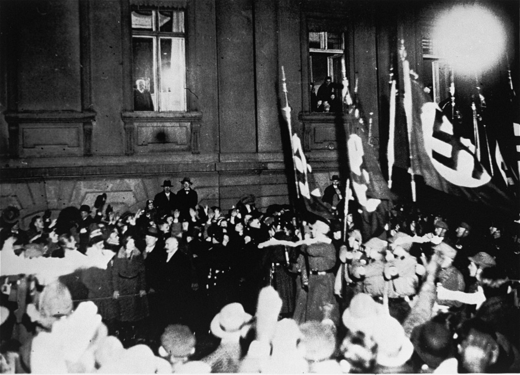 From a window in the Reich Chancellery, German president Paul von Hindenburg watches a Nazi torchlight parade in honor of Hitler's appointment as German Chancellor.